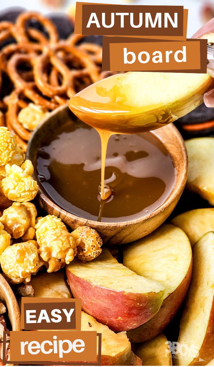 A close-up of an autumn snack board recipe showcases a spoon drizzling caramel over a wooden bowl. Surrounding it are apple slices, popcorn, and pretzels. Text overlays highlight AUTUMN board and EASY recipe.