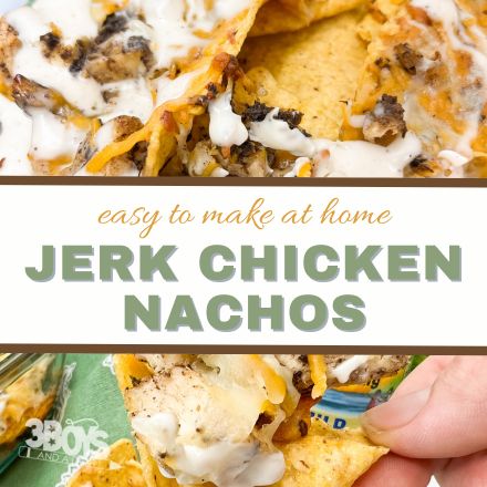 Close-up of Jerk Chicken Nachos loaded with jerk chicken, melted cheese, and a drizzle of white sauce. Text overlay reads “easy to make at home Jerk Chicken Nachos.” A hand holds one cheesy nacho at the bottom—perfect for your next nachos recipe!.