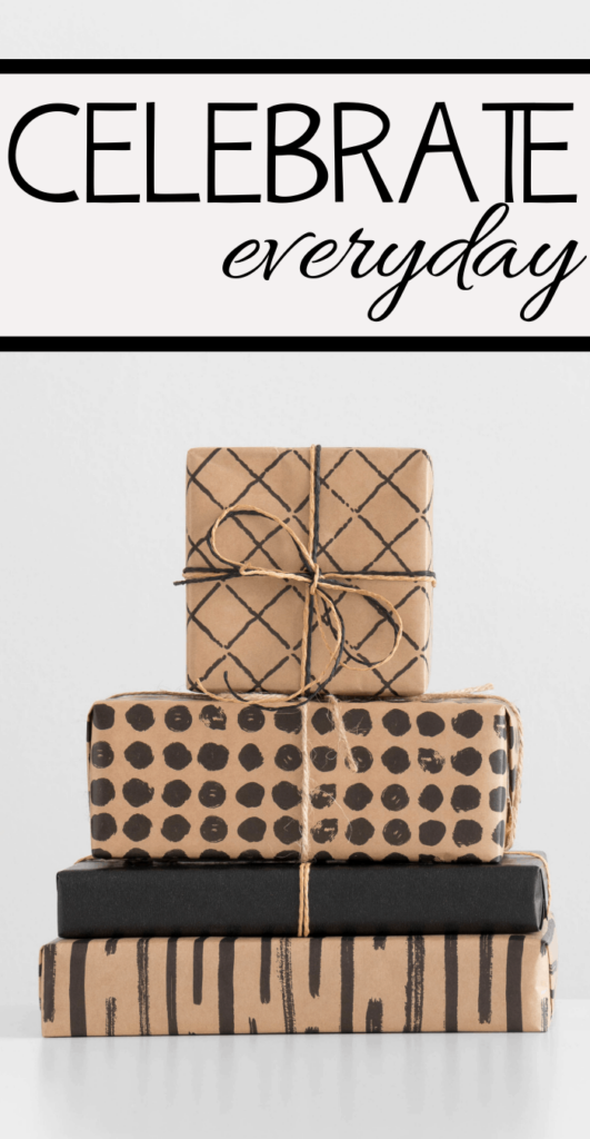 Stack of four gifts wrapped in brown paper with black patterns and twine, set against a pristine white background. Above the gifts, the bold and cursive text reads Celebrate Everyday, inviting you to embrace lifes joyful moments.
