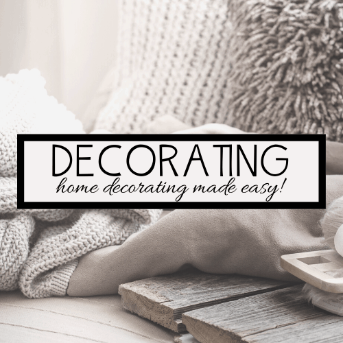 A cozy scene features soft, textured knit blankets and plush pillows in neutral tones. Overlaid text reads, DECORATING: home decorating made easy with Homemaker Tips & Tricks! A wooden tray with decorative items is partially visible in the foreground.