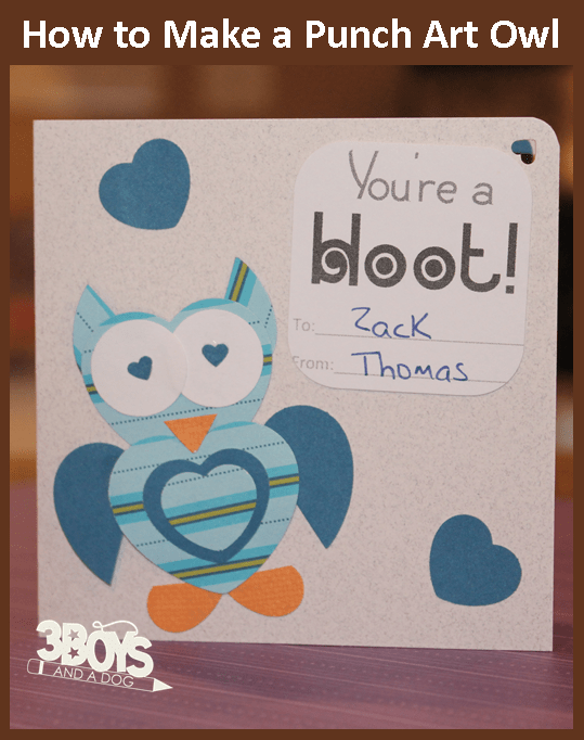A handmade Heart Owl Valentine Card featuring punch art with blue and orange patterned papers. It reads Youre a hoot! with To: Zack From: Thomas penned inside. Blue heart shapes encircle the charming owl, adding an extra touch of affection.